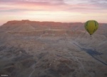 a h ot air balloon in the distance preparing to land